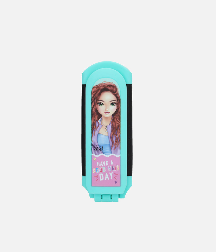 Closed turquoise TOPModel folding hairbrush with an auburn-haired model portrait and printed message
