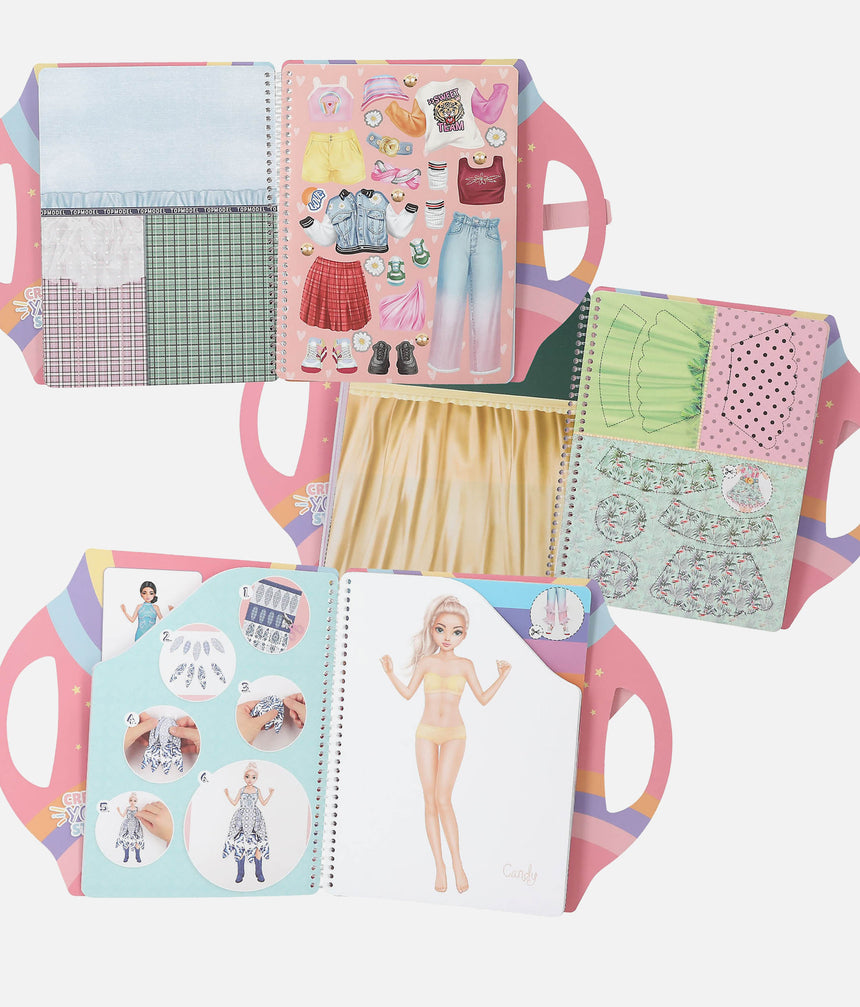 Open book with fashion-themed pages and a paper doll on a white background
