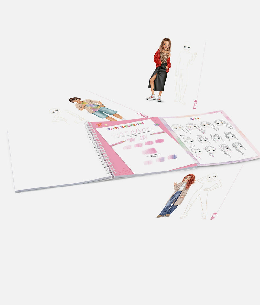 Open planner with fashion design illustrations on a white background