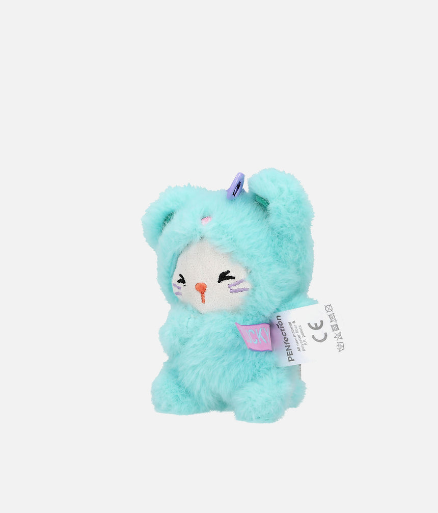 A small plush toy shaped like a bunny or character in a fuzzy mint/aqua costume, with a white face area, embroidered closed eyes, a small orange nose, and a hangtag attached. The background is a clean light gray studio backdrop.
