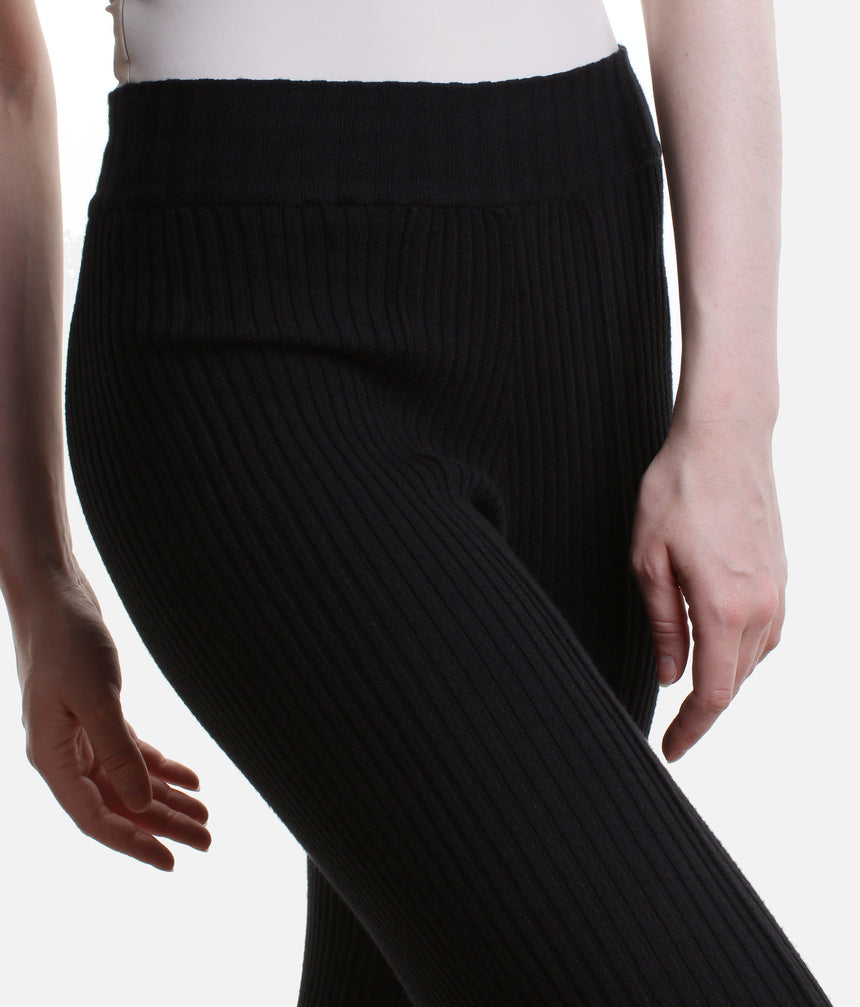 Front close-up of Black Capezio Nolan pants showing the waist-level band and ribbed knit following the hips and upper legs.