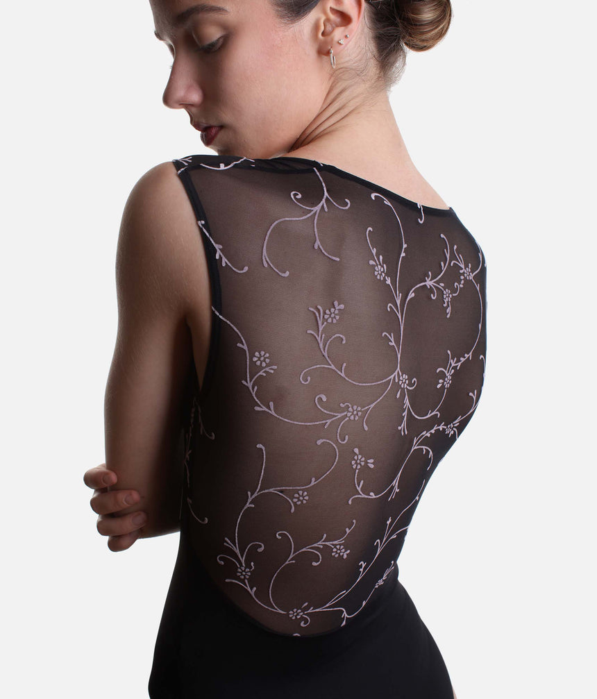 Close-up of the Ilaria leotard’s sheer black tulle back with soft pink trailing flowers.