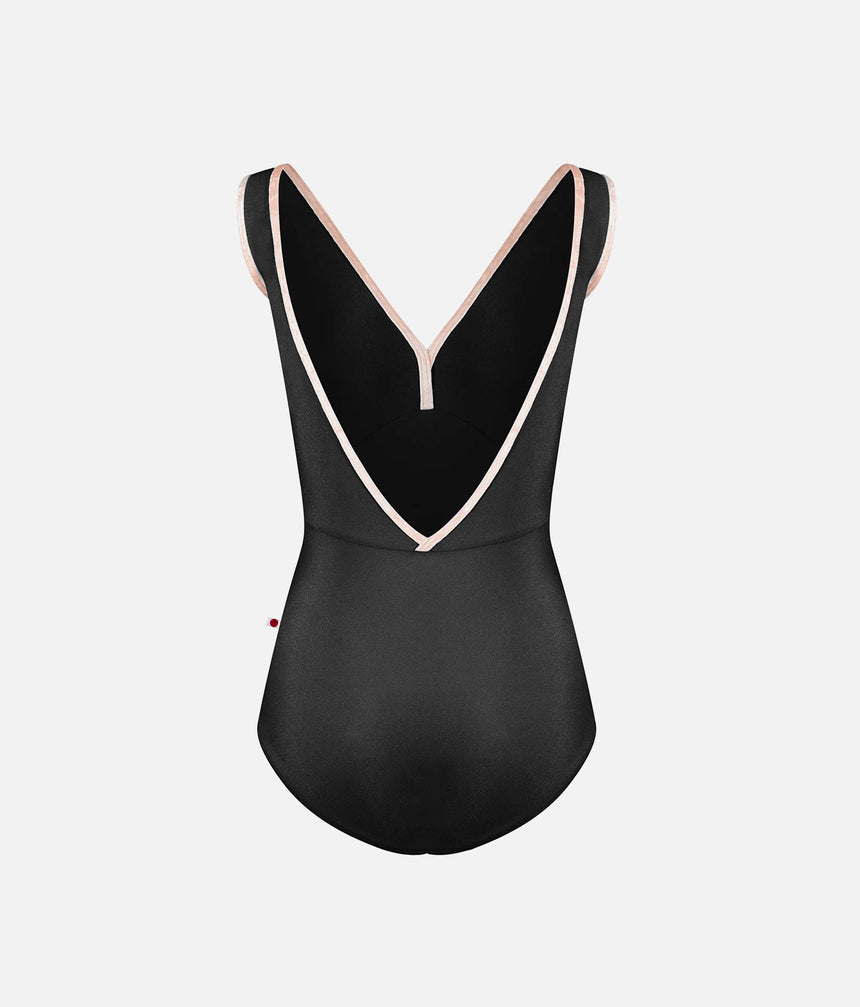 A black one-piece swimsuit with a deep V-neckline and thin shoulder straps, outlined with a contrasting light pink trim, shown against a plain light gray background.