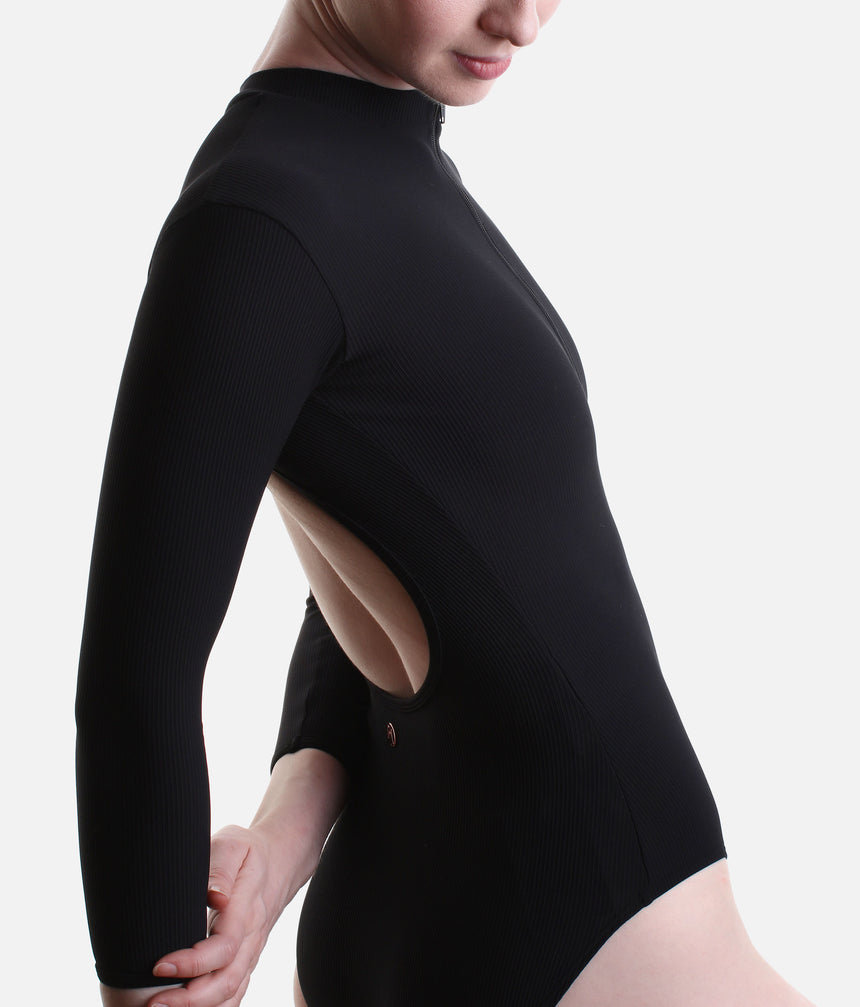 Side view of Mara Dancewear Aura Long Sleeve leotard in Total Black showing the ribbed fabric and open-back cut-out.
