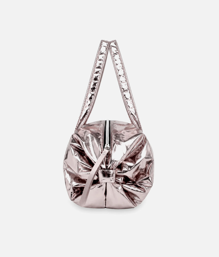 End view of the Repetto B0232NB metallic Copper Pink duffle, showing the rounded shape, side bow and long handles.