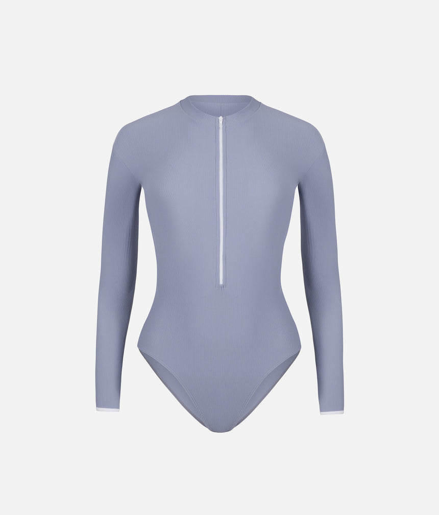 Front view of Mara Dancewear Aura Long Sleeve leotard in Soft Misty Blue with ribbed fabric, high neck and front zip.