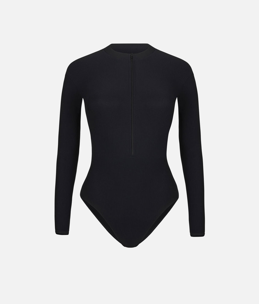 Front worn view of Mara Dancewear Aura Long Sleeve in Total Black with a high neck, long sleeves and front zip.