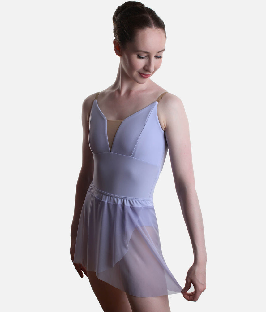 Front view of the Grishko Celine skirt in pale lilac, with one side held out to show the curved mock-wrap hem over a pale blue leotard.
