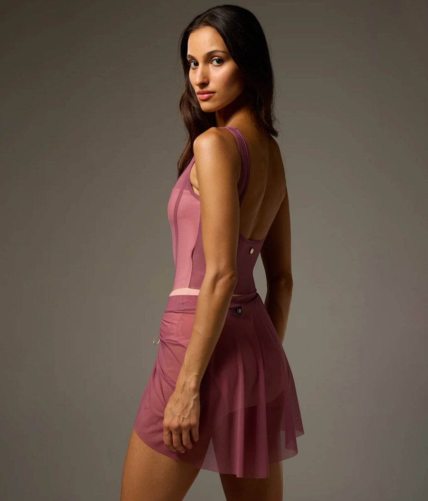 Dancer wearing a Rose Bodile Mika mesh ballet skirt with gathered ruching and a left-side split over a leotard.