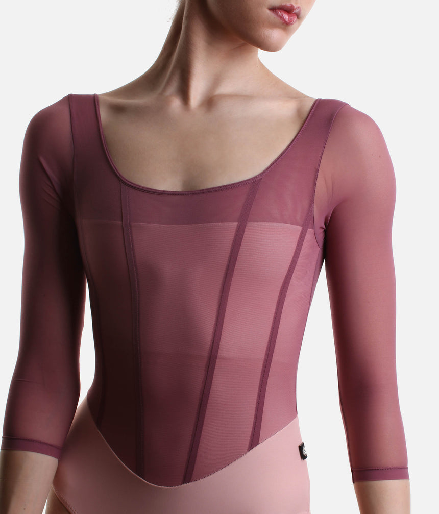 Close-up of Bodile Sofia Mexican Rose leotard, showing the mesh neckline, darker rose corset-style seams and blush pink base.