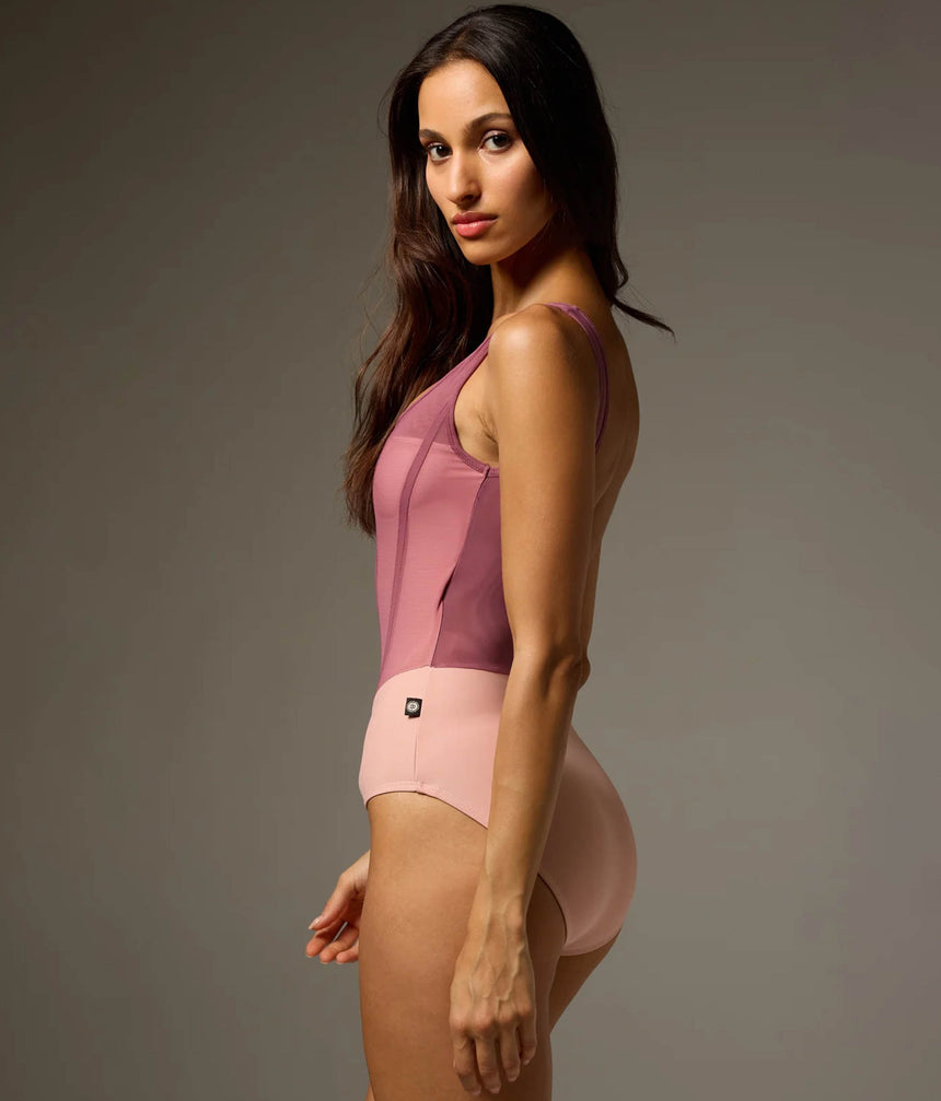 Rear three-quarter view of Bodile Sofia Mexican Rose tank leotard showing its sleeveless cut, low scoop back and blush-pink lower body.