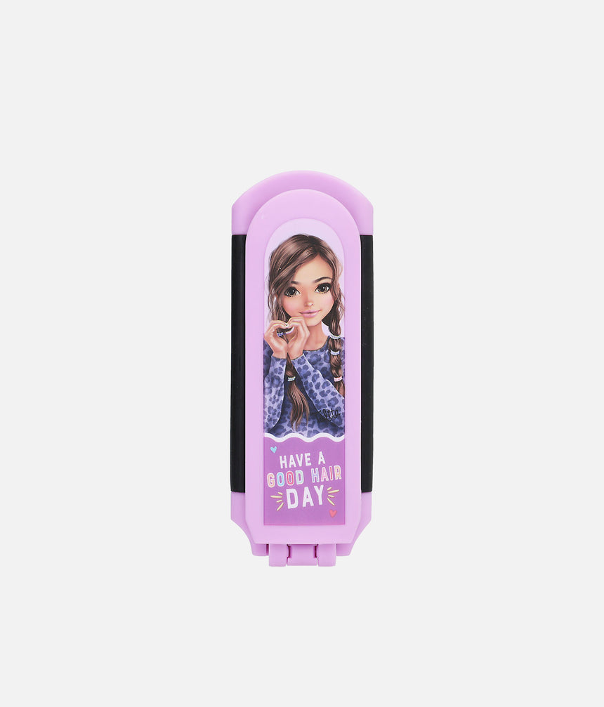 Closed lilac TOPModel folding hairbrush with a brunette model portrait and “Have a good hair day” message