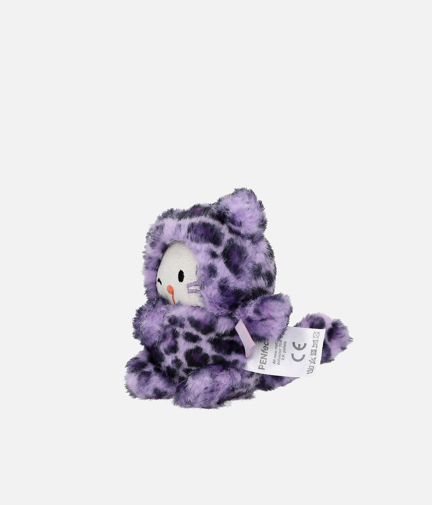 A small plush toy shaped like a cat wearing a purple and black spotted animal-print hooded outfit, with a white face and a hangtag attached, photographed on a plain light gray background.