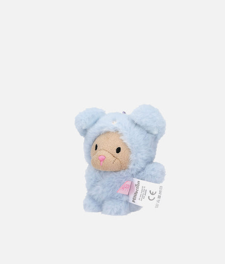 A light blue plush teddy bear keychain or accessory with a beige face, pink nose, and a white hanging tag, shown on a plain light gray background.