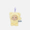 PENfection Tiny Crew Lazy dog bag charm wearing a yellow bear jumpsuit with a purple clip