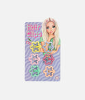 Six TOPModel GLOW TO GO glitter flower hair clips in yellow, lilac, two pink shades, mint and peach on a Candy card