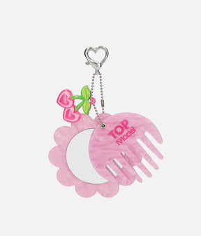 TOPModel GLOW TO GO pink comb slid aside to reveal a flower-framed mirror, with a heart-shaped clip and cherry charm