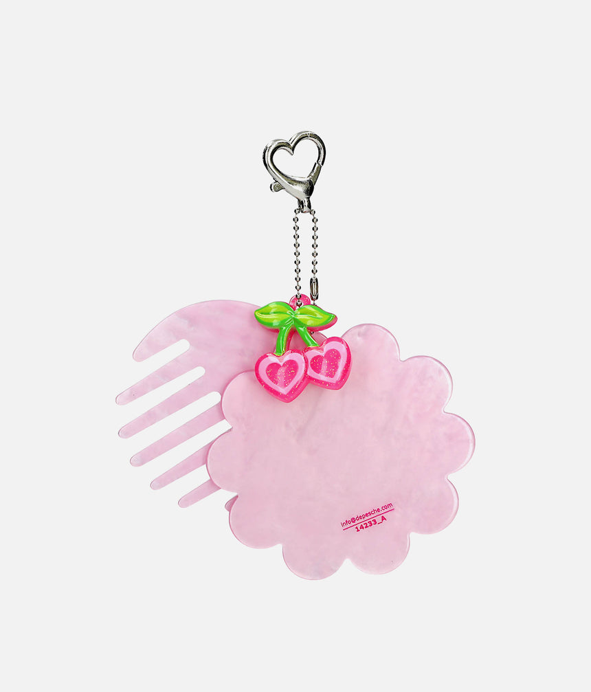 Back of TOPModel GLOW TO GO pink comb and flower-shaped mirror frame with heart-shaped cherry charm and metal chain