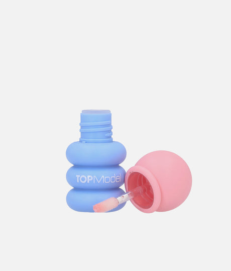 Open blue TOPModel Bubble KPOP lip gloss bottle with peach-pink cap and wand showing peach-coloured gloss