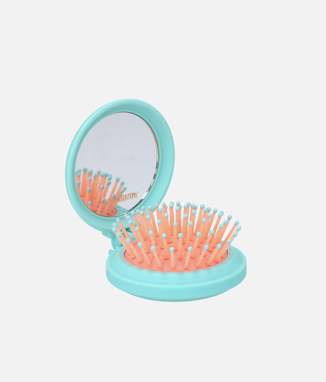 Open turquoise Miss Melody folding hairbrush showing the built-in mirror and peach bristles with aqua rounded tips