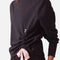Close-up of Repetto S0797 black sweatshirt showing the round neckline, small r logo and gathered side with a pale-pink bow.