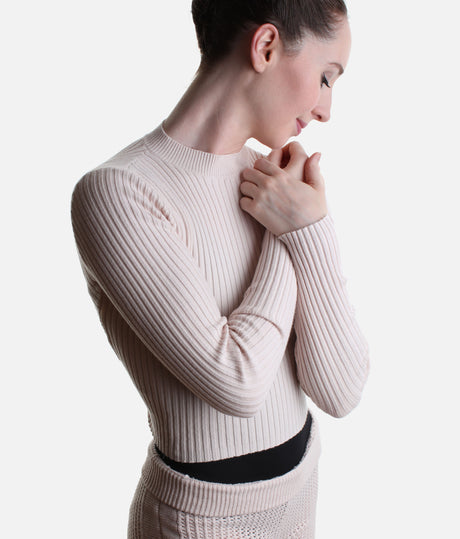 Close-up of the Pink Coppola warm-up top showing the short mock neck, vertical rib texture and fitted long sleeve.