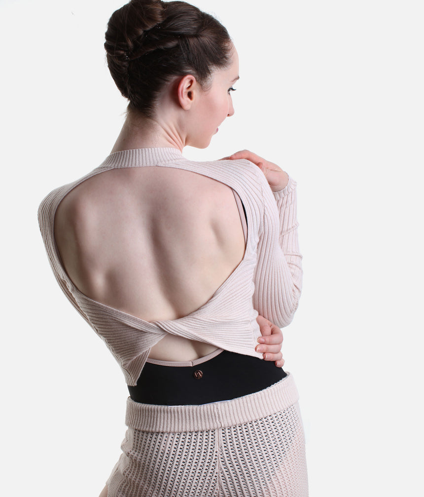 Back view of Pink Capezio Coppola showing the large oval opening and twisted lower back detail, worn over a low-back black leotard.