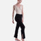 Black Capezio Nolan ribbed knit pants in a crossed-leg pose, showing the opening at the lower-leg hem and the full-length shape.