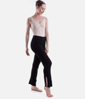 Black Capezio Nolan ribbed knit pants in a crossed-leg pose, showing the opening at the lower-leg hem and the full-length shape.