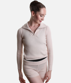 Front view of the Pink Capezio Mise-En-Scene Lynch jumper with the quarter zip open and shawl collar folded down, worn with matching Anderson shorts.