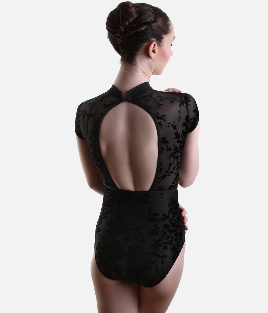 Back view of Black Capezio Rudi leotard showing the large rounded opening, neckband fastening and sheer floral panels around the shoulders.