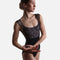 Dancer wearing the black Ilaria cap sleeve leotard, with arms rounded in front beneath the floral bodice.