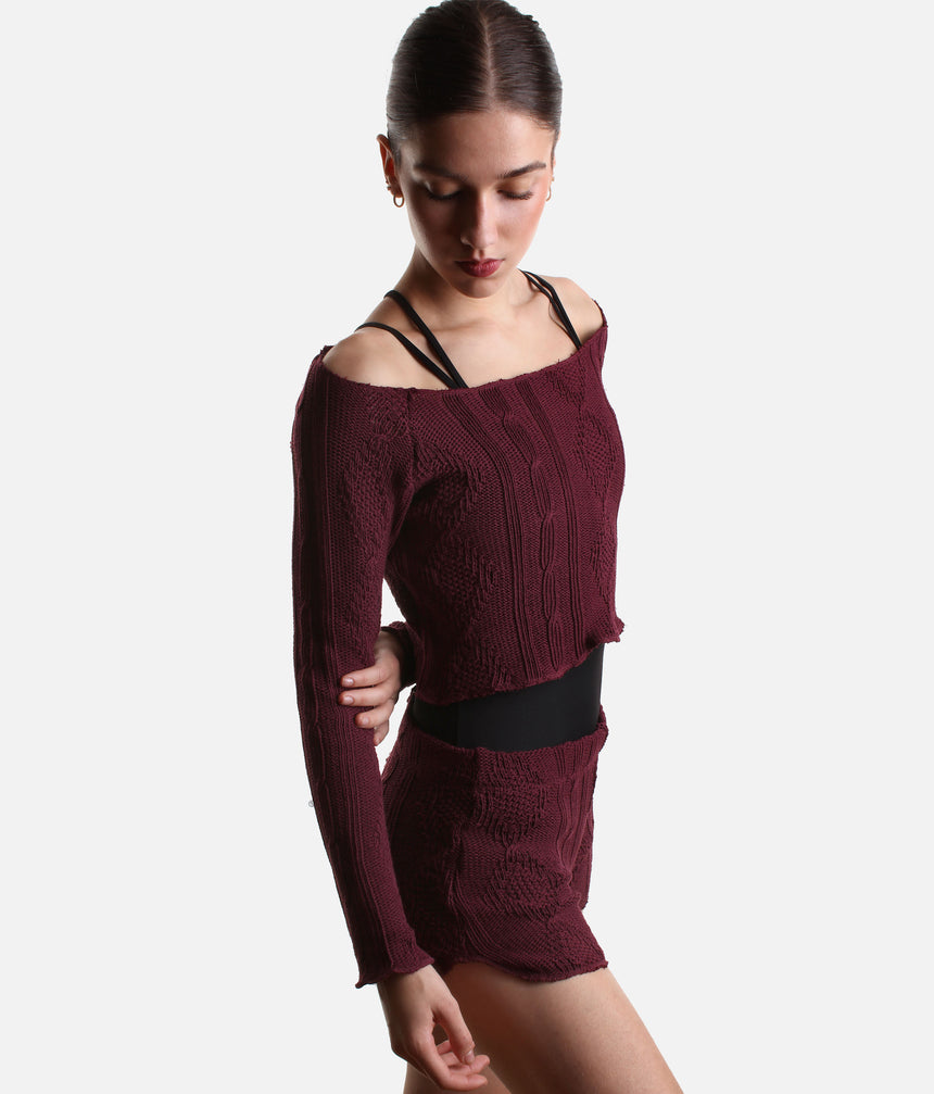Three-quarter view of the burgundy Intermezzo Ismene ballet warm-up sweater layered over a black leotard.