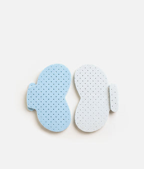 Tendu Inlay Size Changer inserts laid side by side, showing their shaped outline, side tabs and blue and white surfaces.