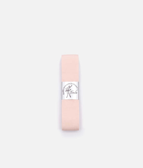 Folded pale pink Tendu pointe shoe ribbon with a silver branded band, displayed flat on a white background.