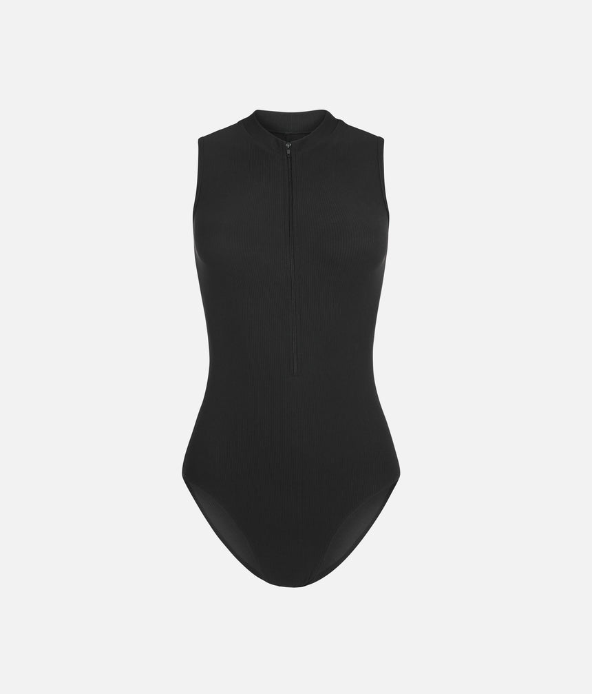 Front of Mara Dancewear Aura Total Black ballet leotard, showing the sleeveless cut, ribbed fabric and matching black zip.