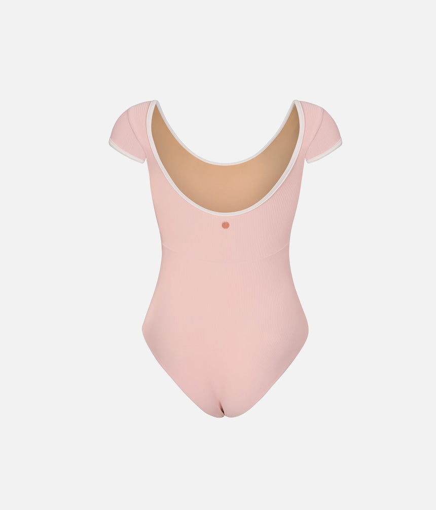 Back of Mara Dancewear Alma Short Sleeve Ballet Pink leotard, showing the pale-trimmed scoop back and front lining inside.