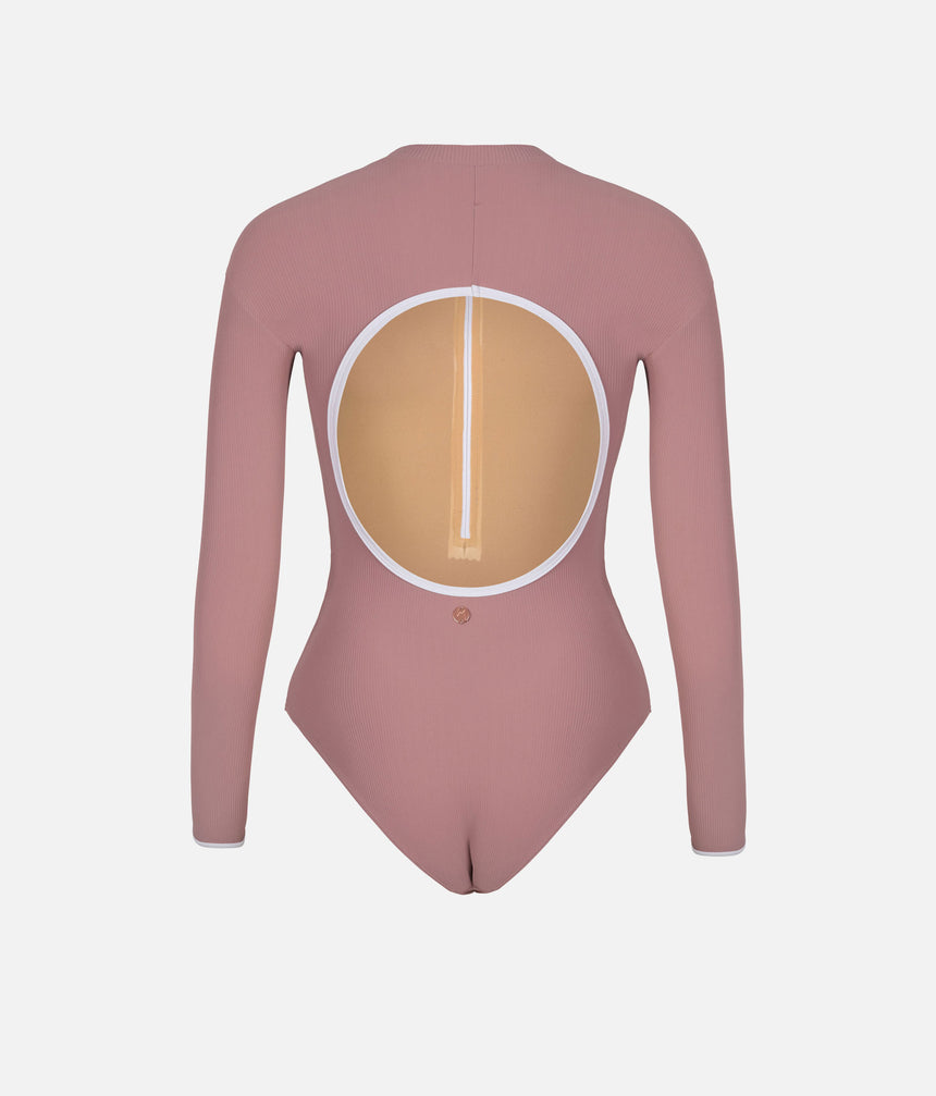Dancer wearing Mara Dancewear Aura Long Sleeve in Dusty Rose, showing the large rounded open back outlined in white.