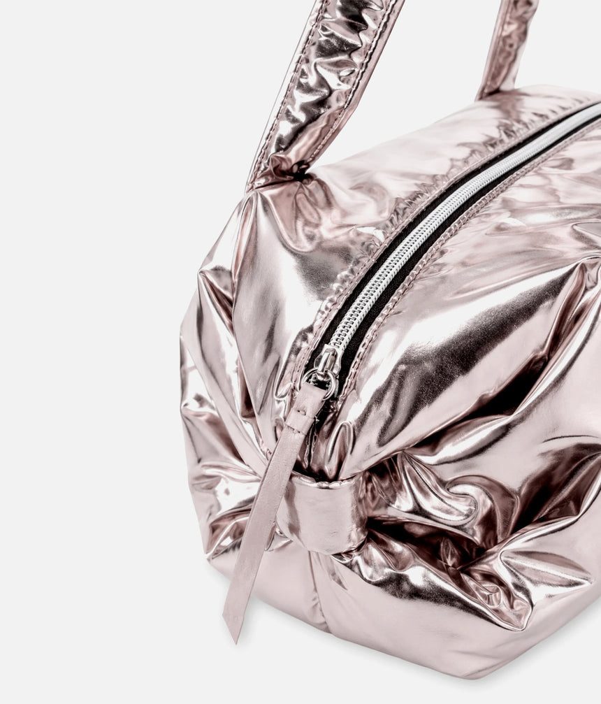 Close-up of the Repetto B0232NB Copper Pink bag showing the metallic finish, top zip, long zip pull and gathered bow detail.