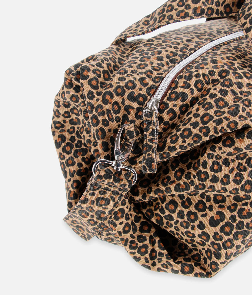 Close-up of the Repetto B0390TL leopard-print bag showing the top zip, metal strap clip and gathered side detail.