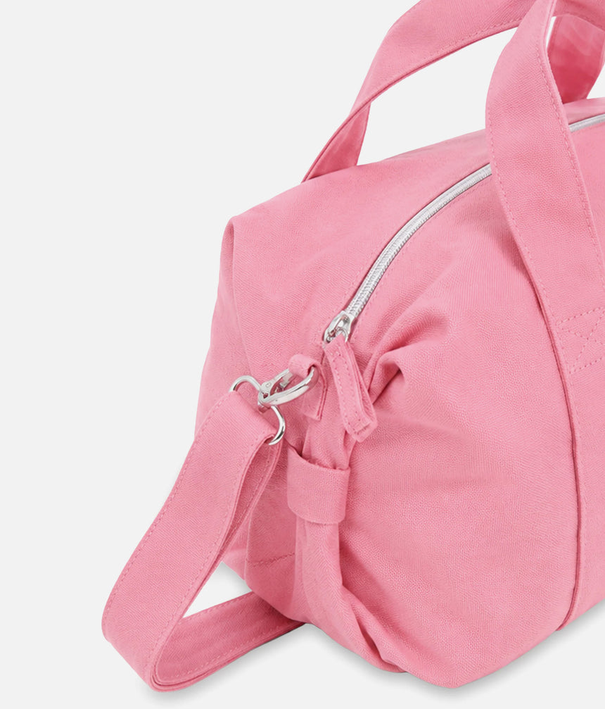 Close-up of the Repetto B0390T pink bag showing the metal strap clip, top zip and gathered side detail.