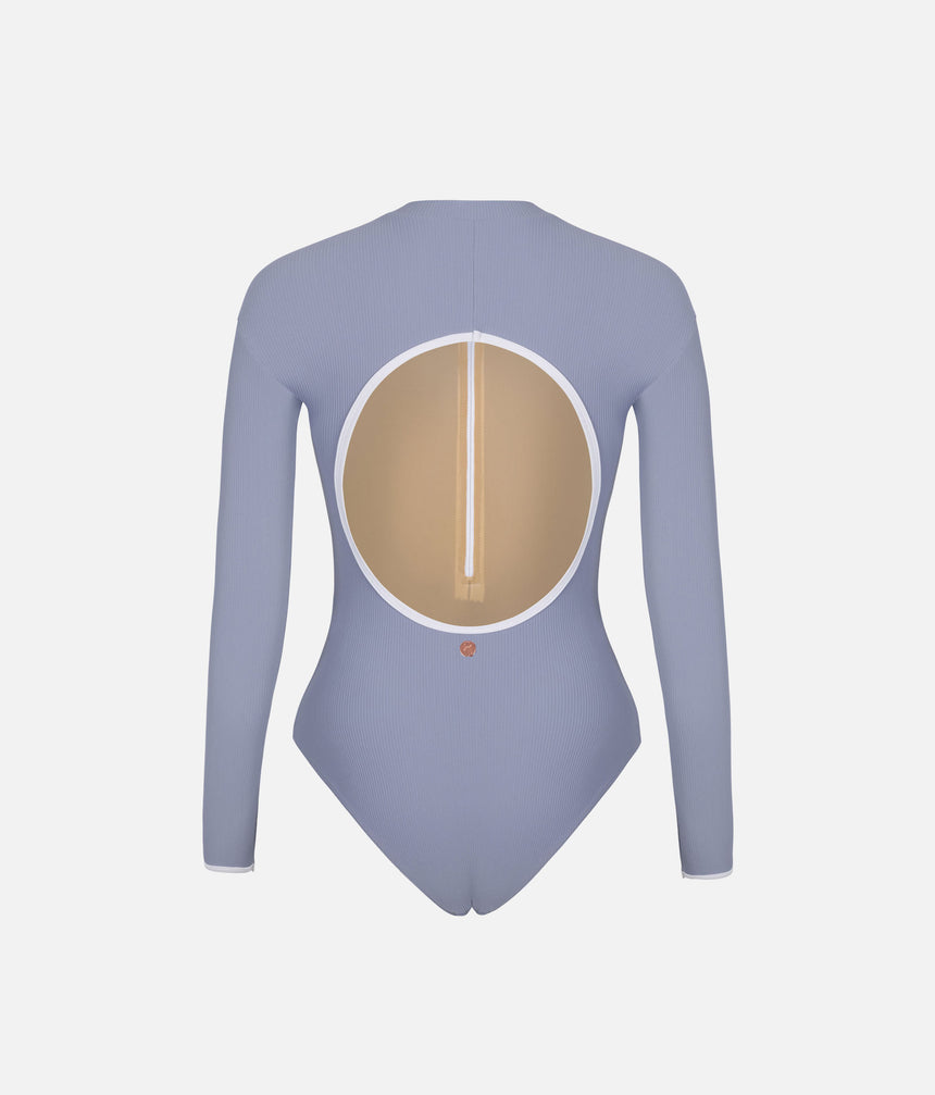 Back view of Mara Dancewear Aura Long Sleeve leotard in Soft Misty Blue with a large rounded open back and pale trim.