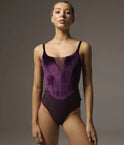 Front of Bodile Bella Fig leotard with violet-plum velvet corset-style panels, a smoky mesh V insert and black camisole straps.