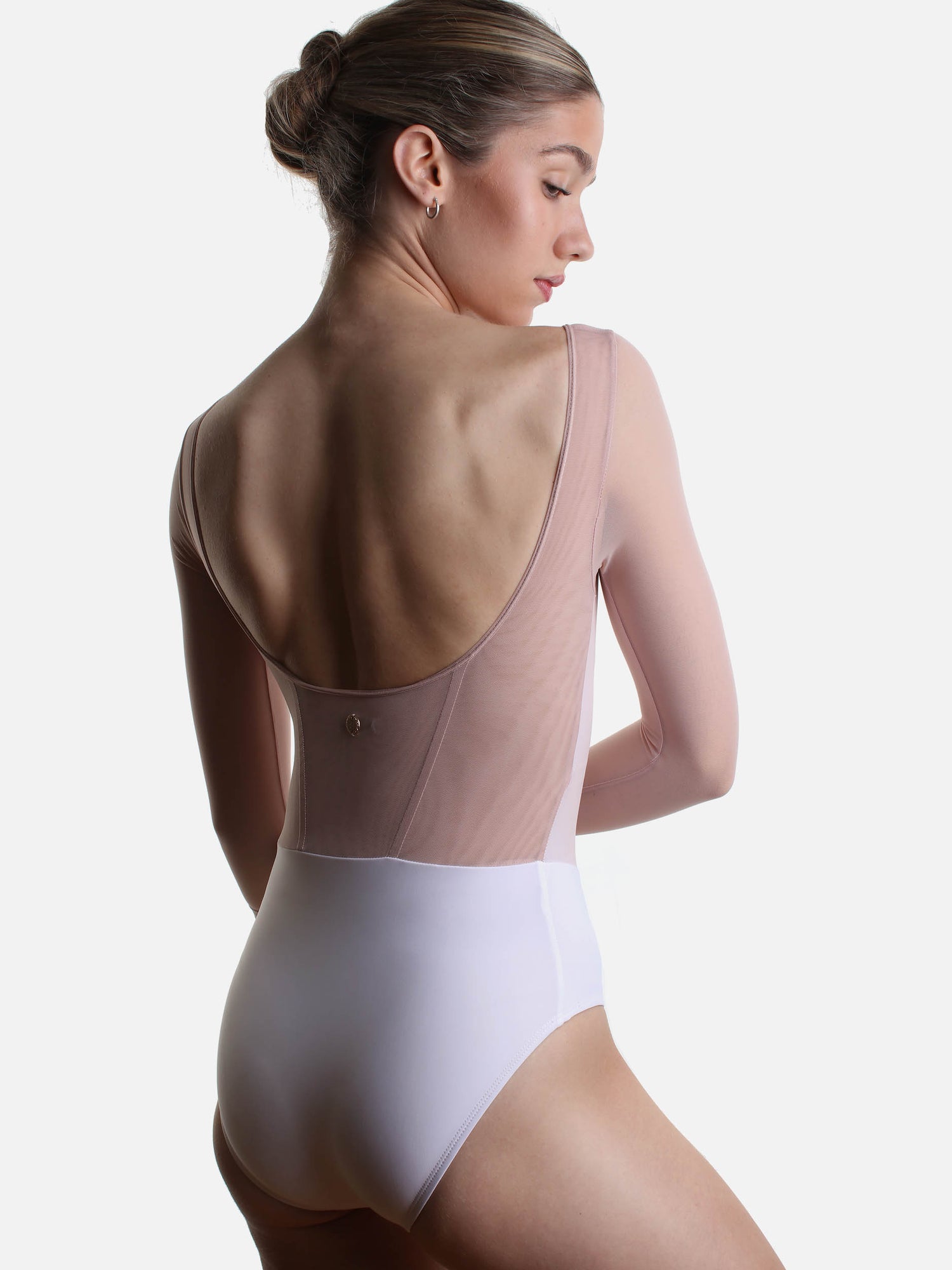 Back of Bodile Sofia Frost Nougat leotard, showing the deep scoop neckline, blush back panel and white lower body.