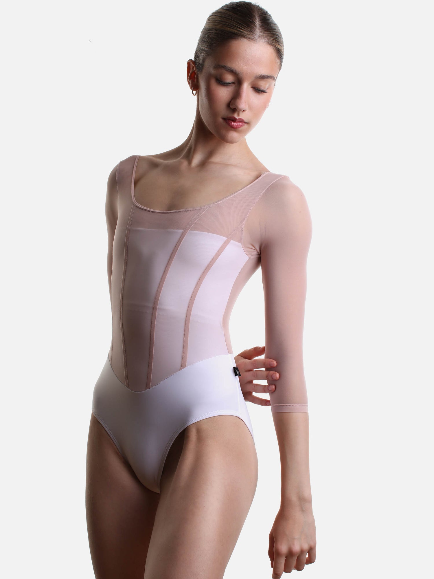Angled front view of Bodile Sofia Frost Nougat leotard, showing the curved neckline and pink bodice seams.