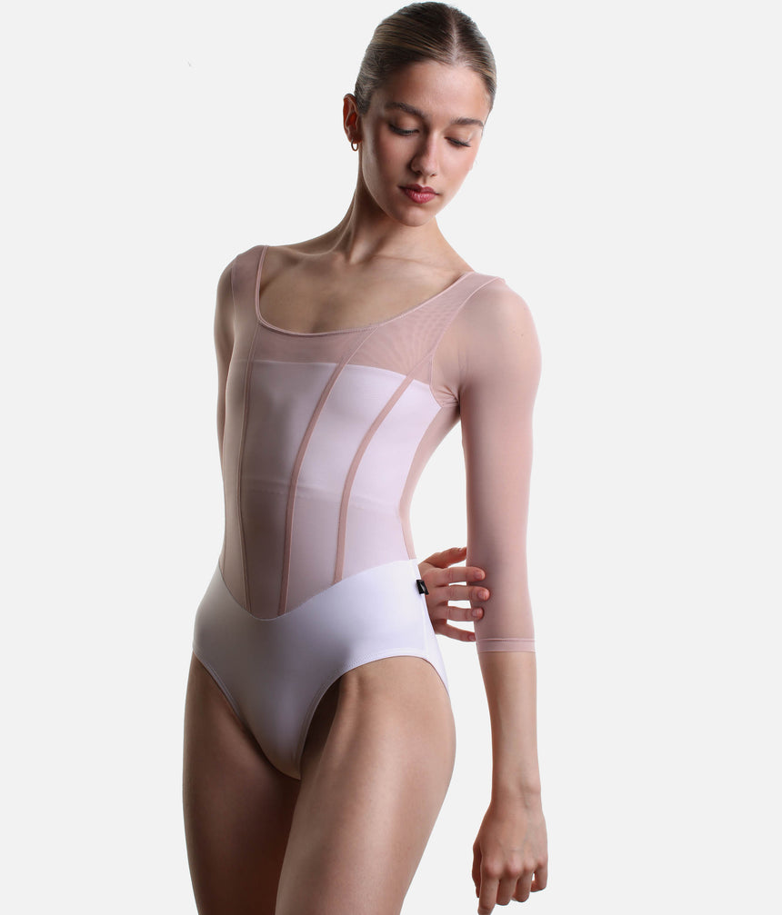 Angled front view of Bodile Sofia Frost Nougat leotard, showing the curved neckline and pink bodice seams.