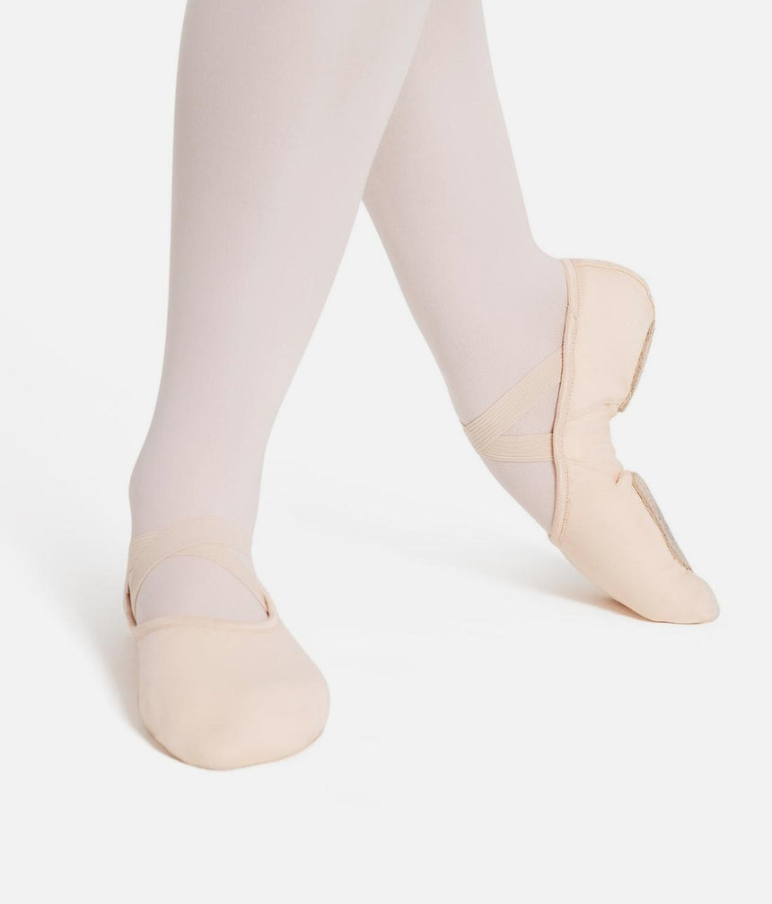 Capezio Hanami Canvas Split-Sole Ballet Shoe worn on crossed feet with pre-sewn crossover elastics.