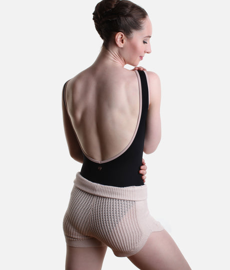 Back view of Pink Capezio Anderson knit shorts worn over a black leotard, showing the open stitch texture and folded ribbed waist.