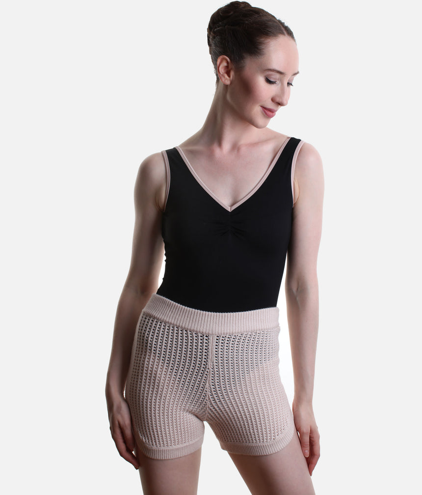 Front detail of Capezio Anderson CK11014W warm-up shorts in Pink, showing the folded ribbed waistband, open pointelle knit and ribbed hems.