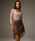 Bodile Gisella rehearsal skirt in smoky plum, showing ribbon ruching and a sheer asymmetric hem.